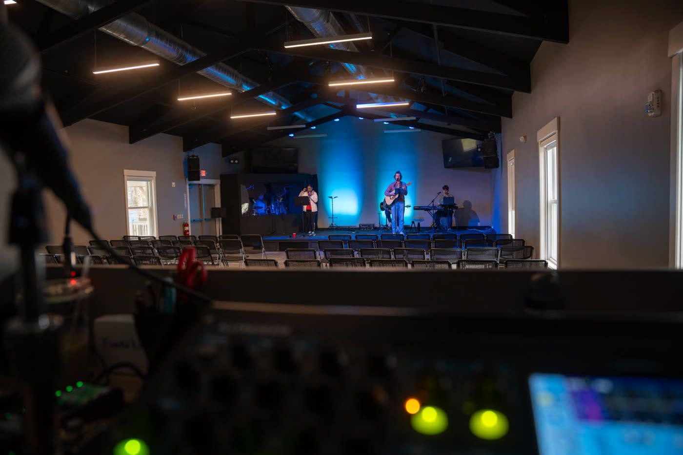 Worship band on stage under blue light