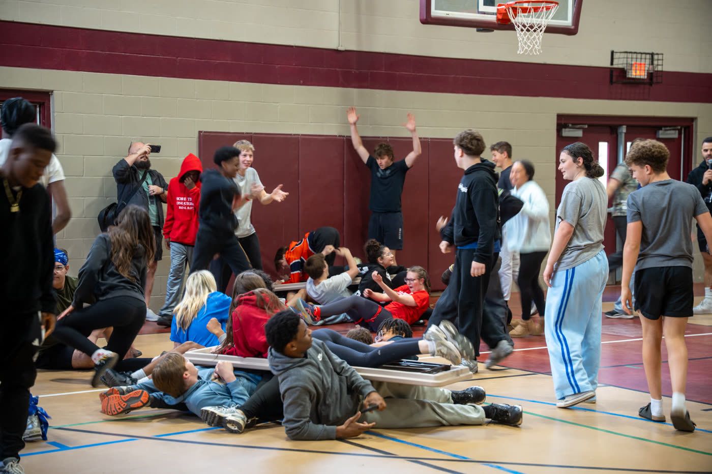 Students piled on the gym floor during a game