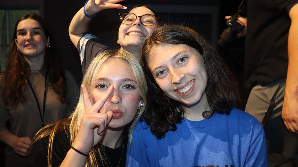 Two friends throwing peace signs at YE25